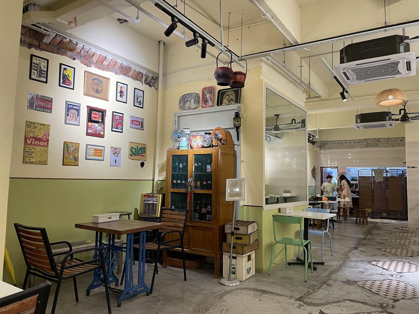 Vintage signs and wooden bottle cabinet inside Din Sun Kopitiam